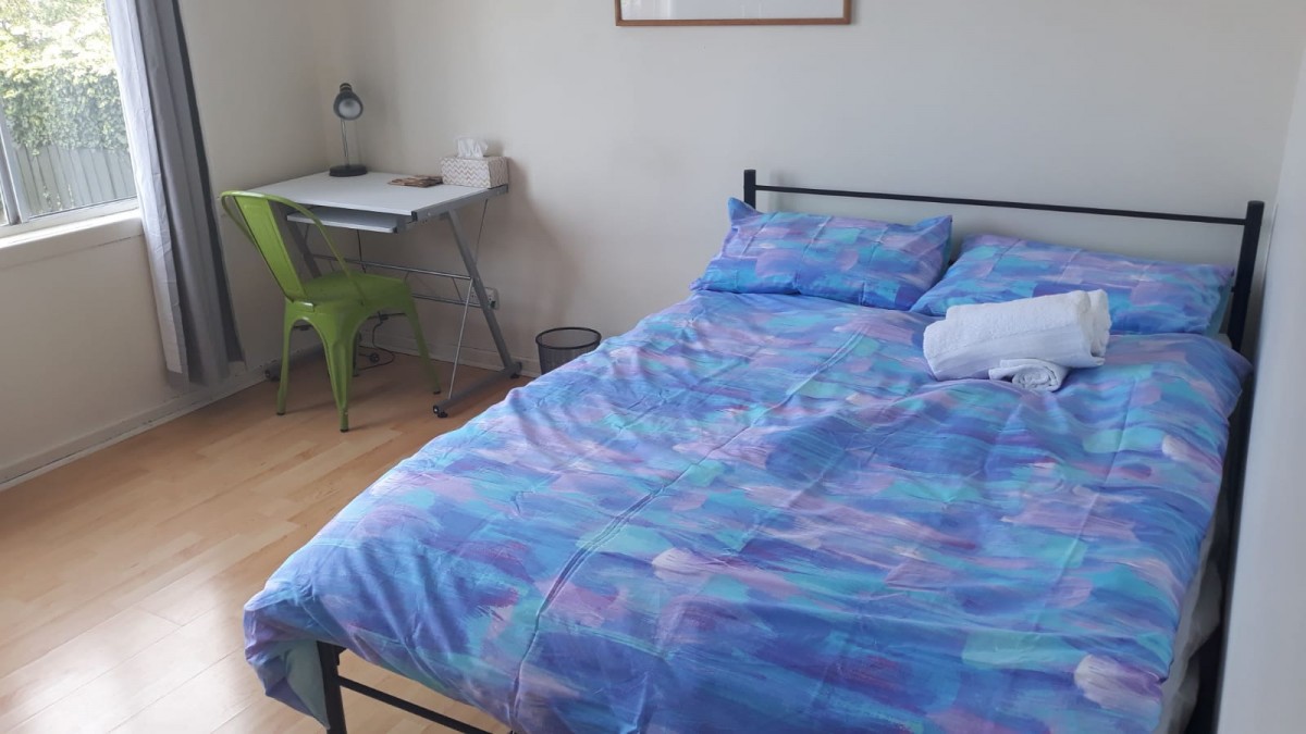 Room 4 Blue bedsheet and desk photo    2.jpeg